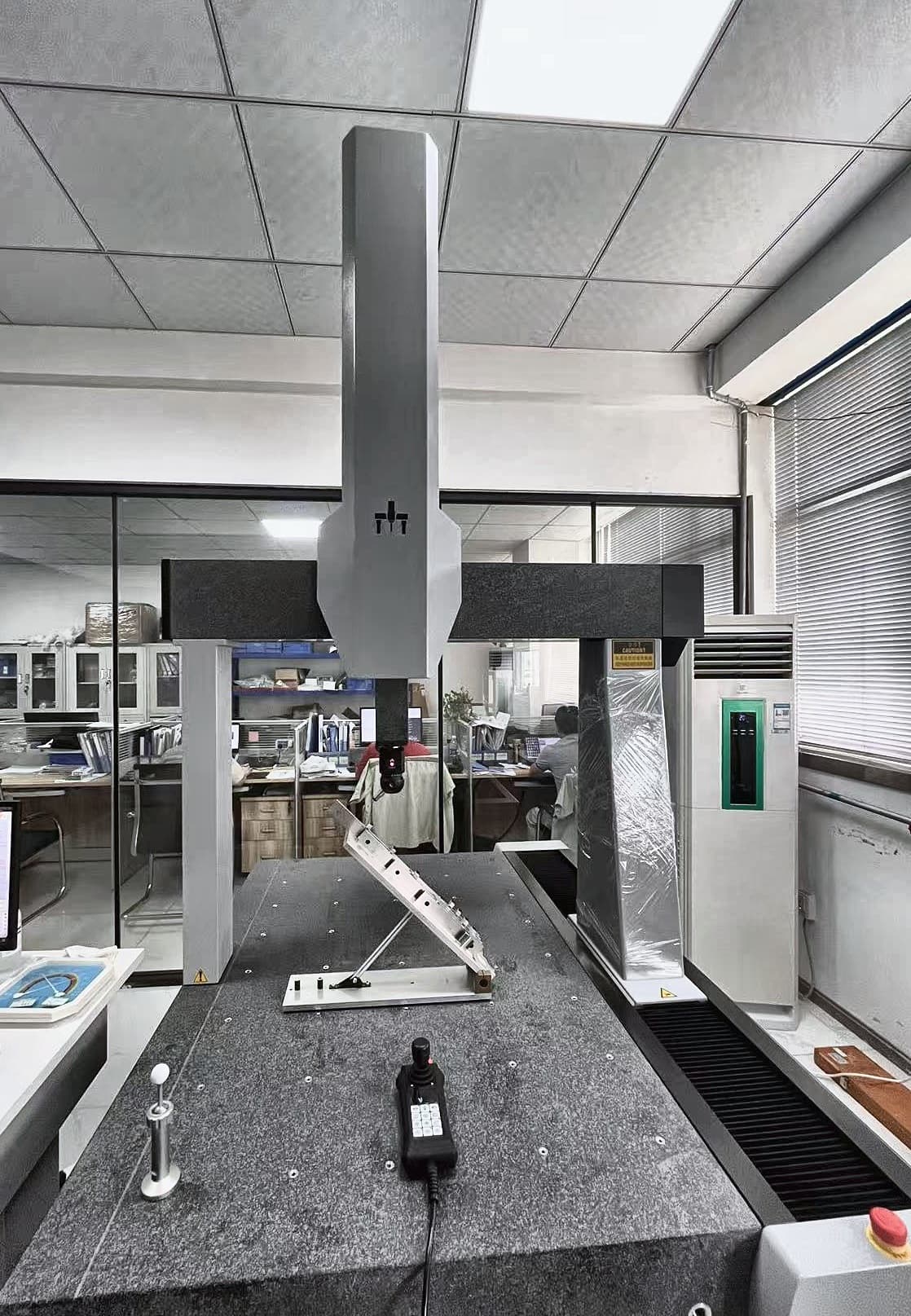Angled fixture supported above a base plate on a Polaris CMM table